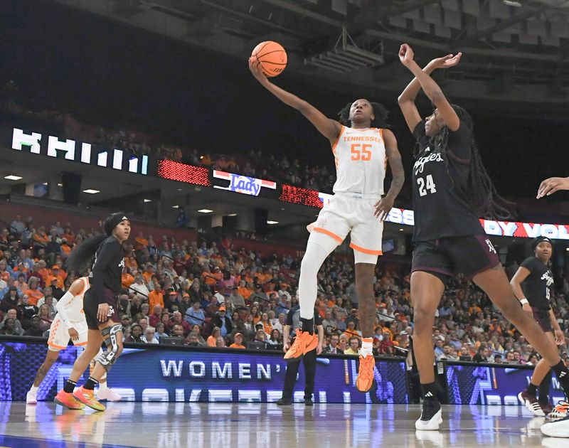 Mar 5, 2025; Greenville, South Carolina, USA; Tennessee guard Talaysia Cooper (55) makes a layup near Texas A&M guard Sahara Jones (24) during the second quarter of the Southeastern Conference Women's Basketball Tournament at Bon Secours Wellness Arena.  Mandatory Credit: Ken Ruinard/USA TODAY NETWORK via Imagn Images