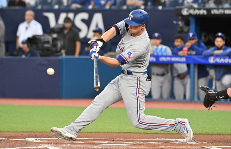 Sep 14, 2023; Toronto, Ontario, CAN;   Texas Rangers shortstop Corey Seager (5) hits a solo home run against he Toronto Blue Jays in the first inning at Rogers Centre. Mandatory Credit: Dan Hamilton-USA TODAY Sports