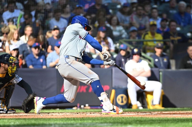 Sep 29, 2024; Milwaukee, Wisconsin, USA; New York Mets shortstop Francisco Lindor (12) gets a base hit against the Milwaukee Brewers in the fourth inning at American Family Field. Mandatory Credit: Michael McLoone-Imagn Images