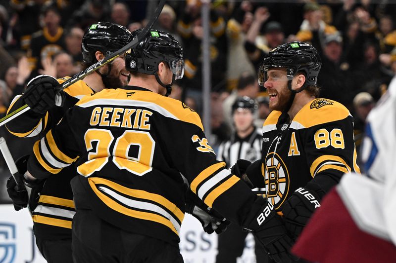 Jan 25, 2025; Boston, Massachusetts, USA; Boston Bruins center Morgan Geekie (39) celebrates with right wing David Pastrnak (88) after scoring a goal against the Colorado Avalanche during the third period at the TD Garden. Mandatory Credit: Brian Fluharty-Imagn Images