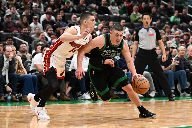 BOSTON, MASSACHUSETTS - DECEMBER 02: Payton Pritchard #11 of the Boston Celtics goes to the basket against Tyler Herro #14 of the Miami Heat during the fourth quarter at the TD Garden on December 02, 2024 in Boston, Massachusetts. NOTE TO USER: User expressly acknowledges and agrees that, by downloading and or using this photograph, User is consenting to the terms and conditions of the Getty Images License Agreement. (Photo by Brian Fluharty/Getty Images)