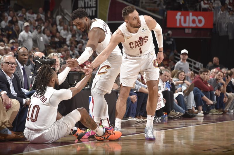 CLEVELAND, OH - APRIL 22: Darius Garland #10 of the Cleveland Cavaliers is helped up by Donovan Mitchell #45 and Max Strus #1 during the game against the Orlando Magic during Round 1 Game 2 of the 2024 NBA Playoffs on April 22, 2024 at Rocket Mortgage FieldHouse in Cleveland, Ohio. NOTE TO USER: User expressly acknowledges and agrees that, by downloading and/or using this Photograph, user is consenting to the terms and conditions of the Getty Images License Agreement. Mandatory Copyright Notice: Copyright 2024 NBAE (Photo by David Liam Kyle/NBAE via Getty Images)