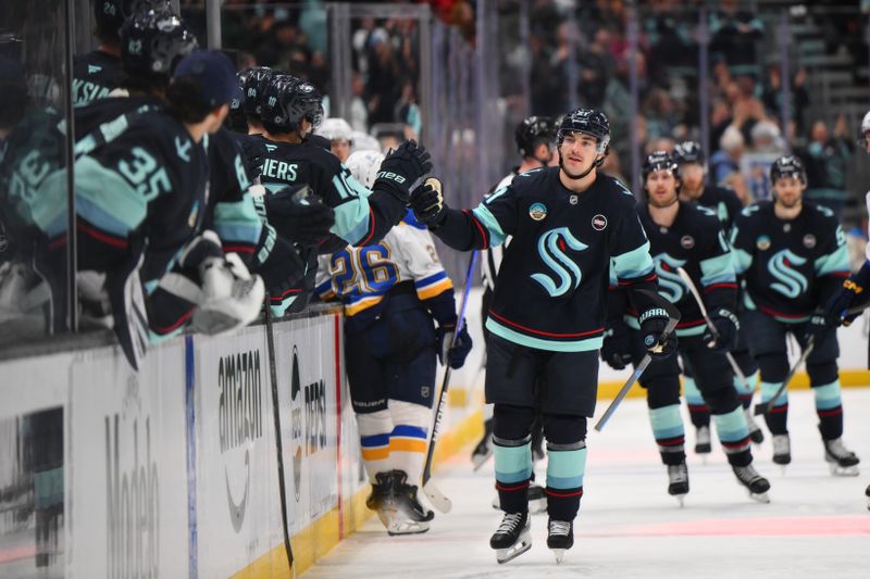 Apr 12, 2025; Seattle, Washington, USA; Seattle Kraken center Michael Eyssimont (21) celebrates with the bench after scoring a goal against the St. Louis Blues during the third period at Climate Pledge Arena. Mandatory Credit: Steven Bisig-Imagn Images