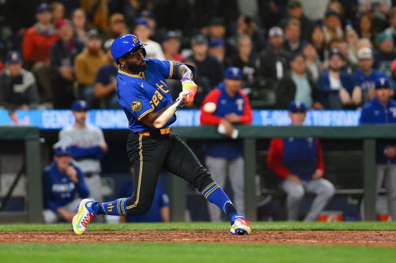 Sep 14, 2024; Seattle, Washington, USA; Seattle Mariners designated hitter Randy Arozarena (56) hits a walk-off single against the Texas Rangers during the ninth inning at T-Mobile Park. Mandatory Credit: Steven Bisig-Imagn Images