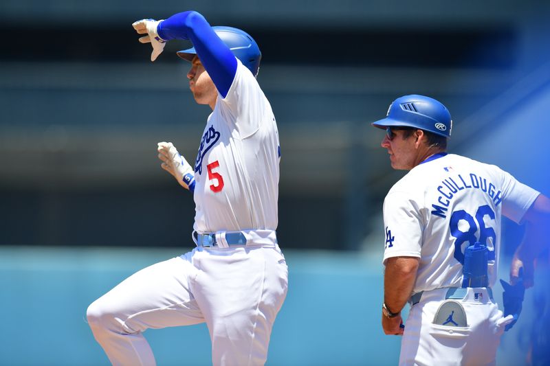 Jun 16, 2024; Los Angeles, California, USA; Los Angeles Dodgers first base Freddie Freeman (5) reaches first on a single against the Kansas City Royals during the first inning at Dodger Stadium. Mandatory Credit: Gary A. Vasquez-USA TODAY Sports