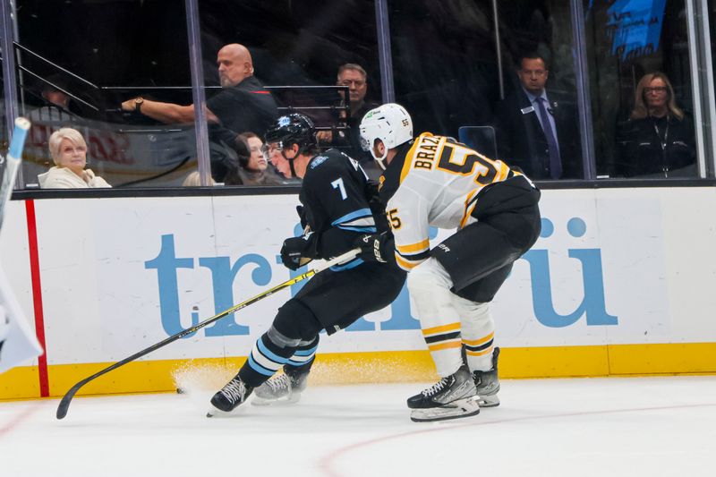 Oct 19, 2024; Salt Lake City, Utah, USA; Boston Bruin Justin Brezr=eau chase sUtah’s Michael Kessering at Delta Center. Mandatory Credit: Harry Caston-Imagn Images