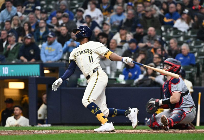 Apr 3, 2024; Milwaukee, Wisconsin, USA; Milwaukee Brewers right fielder Jackson Chourio (11) hits his first Major League home run agaisnt the Minnesota Twins in the fifth inning at American Family Field. Mandatory Credit: Michael McLoone-USA TODAY Sports