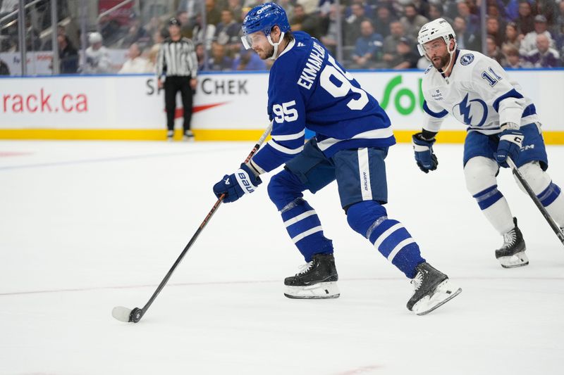 Oct 21, 2024; Toronto, Ontario, CAN; Toronto Maple Leafs defenseman Oliver Ekman-Larsson (95) carries the puck against the Tampa Bay Lightning during the second period at Scotiabank Arena. Mandatory Credit: John E. Sokolowski-Imagn Images