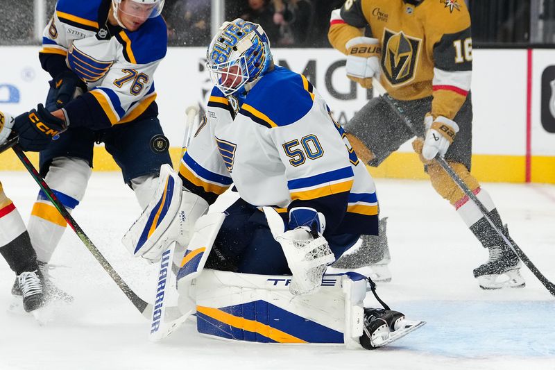 Oct 11, 2024; Las Vegas, Nevada, USA; St. Louis Blues goaltender Jordan Binnington (50) makes a save against Vegas Golden Knights center Jack Eichel (9) during the second period at T-Mobile Arena. Mandatory Credit: Stephen R. Sylvanie-Imagn Images