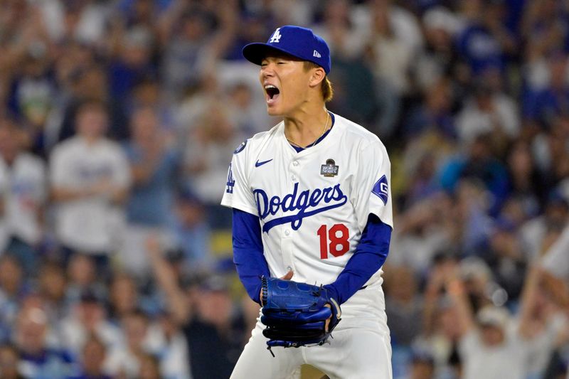 Oct 26, 2024; Los Angeles, California, USA; Los Angeles Dodgers pitcher Yoshinobu Yamamoto (18) reacts in the fourth inning against the New York Yankees during game two of the 2024 MLB World Series at Dodger Stadium. Mandatory Credit: Jayne Kamin-Oncea-Imagn Images