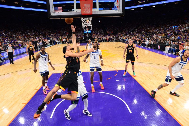 PHOENIX, AZ - APRIL  26: Devin Booker #1 of the Phoenix Suns drives to the basket during the game against the Minnesota Timberwolves on April 26, 2024 at Footprint Center in Phoenix, Arizona. NOTE TO USER: User expressly acknowledges and agrees that, by downloading and or using this photograph, user is consenting to the terms and conditions of the Getty Images License Agreement. Mandatory Copyright Notice: Copyright 2024 NBAE (Photo by Kate Frese/NBAE via Getty Images)