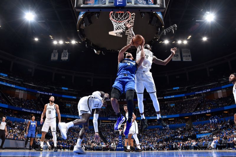 ORLANDO, FL - OCTOBER 25: Jalen Suggs #4 of the Orlando Magic drives to the basket during the game against the Brooklyn Nets on October 25, 2024 at Kia Center in Orlando, Florida. NOTE TO USER: User expressly acknowledges and agrees that, by downloading and or using this photograph, User is consenting to the terms and conditions of the Getty Images License Agreement. Mandatory Copyright Notice: Copyright 2024 NBAE (Photo by Fernando Medina/NBAE via Getty Images)