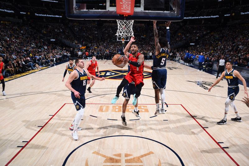 DENVER, CO - JANUARY 17: Damian Lillard #0 of the Portland Trail Blazers drives to the basket during the game against the Denver Nuggets on January 17, 2023 at the Ball Arena in Denver, Colorado. NOTE TO USER: User expressly acknowledges and agrees that, by downloading and/or using this Photograph, user is consenting to the terms and conditions of the Getty Images License Agreement. Mandatory Copyright Notice: Copyright 2023 NBAE (Photo by Garrett Ellwood/NBAE via Getty Images)