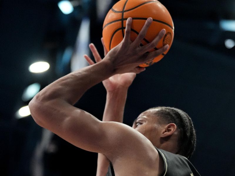 Jan 28, 2025; Lawrence, Kansas, USA; Kansas Jayhawks guard Rakease Passmore (4) shoots a jump shot against the Kansas Jayhawks during the first half at Allen Fieldhouse. Mandatory Credit: Denny Medley-Imagn Images