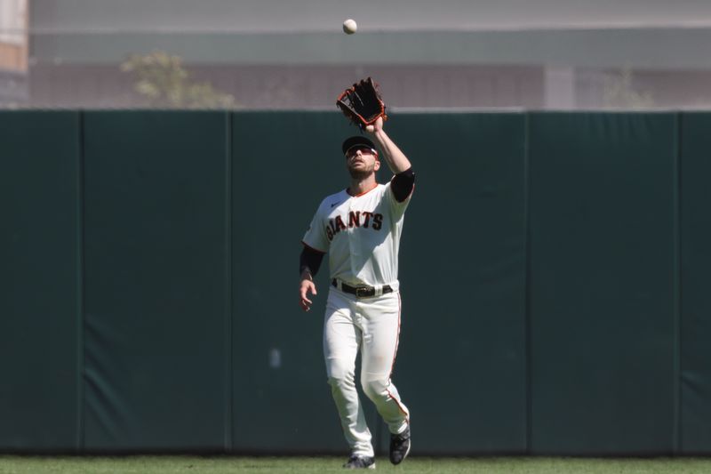 Sep 13, 2023; San Francisco, California, USA; San Francisco Giants left fielder Austin Slater (13) catches a fly out during the fourth inning against the Cleveland Guardians at Oracle Park. Mandatory Credit: Sergio Estrada-USA TODAY Sports