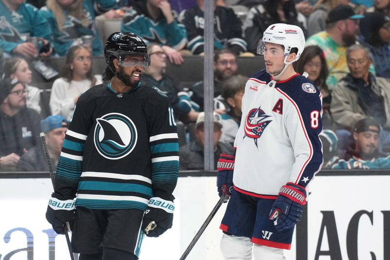 Feb 17, 2024; San Jose, California, USA; San Jose Sharks left wing Anthony Duclair (10) and Columbus Blue Jackets defenseman Zach Werenski (8) talk during the second period at SAP Center at San Jose. Mandatory Credit: Darren Yamashita-USA TODAY Sports