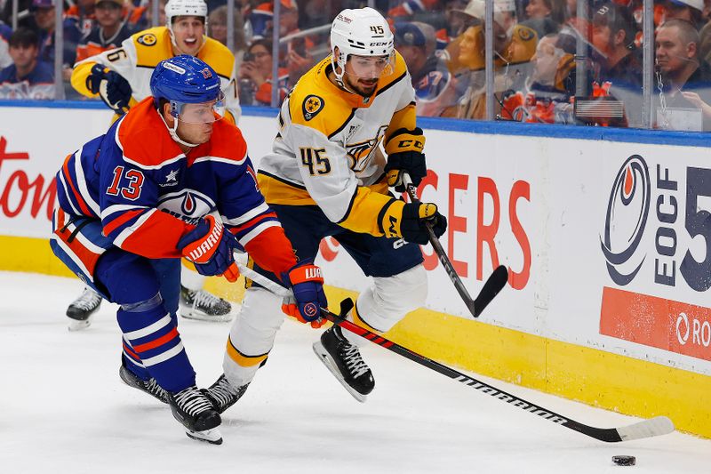 Nov 14, 2024; Edmonton, Alberta, CAN; Edmonton Oilers forward Mattias Janmark (13) tries to protect the puck from. Nashville Predators defensemen Alex Carrier (45) during the third period at Rogers Place. Mandatory Credit: Perry Nelson-Imagn Images