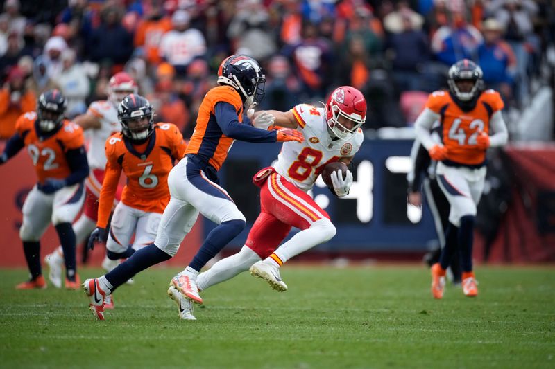 Denver Broncos cornerback Pat Surtain II (2) stops Kansas City Chiefs wide receiver Justin Watson (84) in the second half of an NFL football game Sunday, Oct. 29, 2023, in Denver. (AP Photo/David Zalubowski)