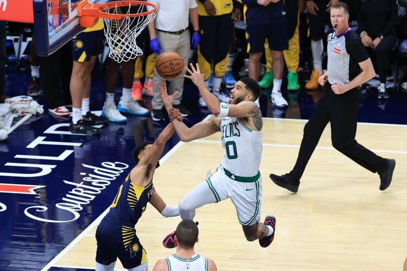 INDIANAPOLIS, INDIANA - OCTOBER 30:  Jayson Tatum #0 of the Boston Celtics is fouled by Tyrese Haliburton #0 of the Indiana Pacers during the second half at Gainbridge Fieldhouse on October 30, 2024 in Indianapolis, Indiana. NOTE TO USER: User expressly acknowledges and agrees that, by downloading and or using this photograph, User is consenting to the terms and conditions of the Getty Images License Agreement. (Photo by Justin Casterline/Getty Images)