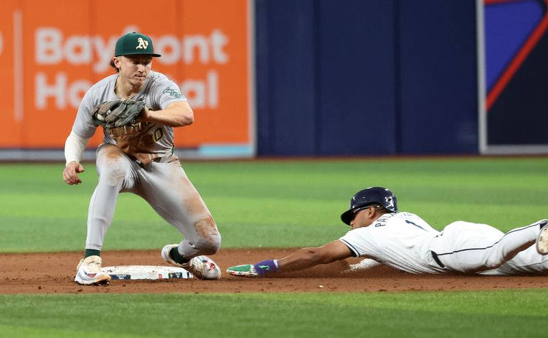 May 30, 2024; St. Petersburg, Florida, USA; Tampa Bay Rays outfielder Richie Palacios (1) slides safe into second base as Oakland Athletics second base Zack Gelof (20) attempts to tag him out during the tenth inning at Tropicana Field. Mandatory Credit: Kim Klement Neitzel-USA TODAY Sports