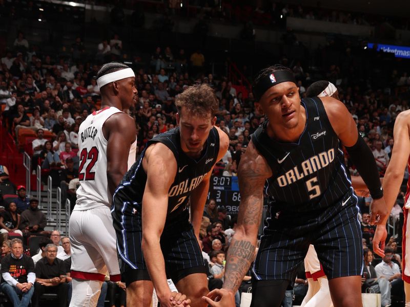 MIAMI, FL - OCTOBER 23: Franz Wagner #22 and Paolo Banchero #5 help up Jalen Suggs #4 of the Orlando Magic during the game against the Houston Rockets on October 23, 2024 at Kaseya Center in Miami, Florida. NOTE TO USER: User expressly acknowledges and agrees that, by downloading and or using this Photograph, user is consenting to the terms and conditions of the Getty Images License Agreement. Mandatory Copyright Notice: Copyright 2024 NBAE (Photo by Issac Baldizon/NBAE via Getty Images)