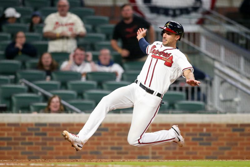 Apr 11, 2022; Atlanta, Georgia, USA; Atlanta Braves first baseman Matt Olson (28) slides home safely against the Washington Nationals in the ninth inning at Truist Park. Mandatory Credit: Brett Davis-USA TODAY Sports
