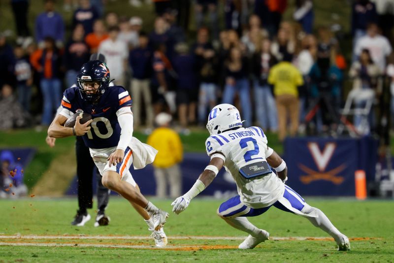 Nov 18, 2023; Charlottesville, Virginia, USA; Virginia Cavaliers quarterback Anthony Colandrea (10) carries the ball as Duke Blue Devils safety Jaylen Stinson (2) chases during the fourth quarter at Scott Stadium. Mandatory Credit: Geoff Burke-USA TODAY Sports