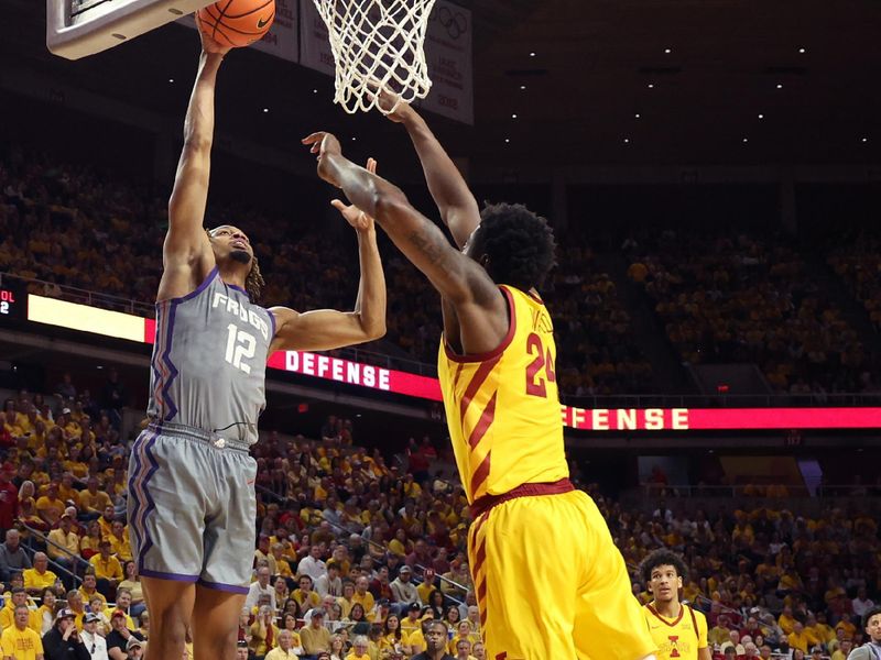 Feb 10, 2024; Ames, Iowa, USA; TCU Horned Frogs forward Xavier Cork (12) scores against owa State Cyclones forward Hason Ward (24) during the second half at James H. Hilton Coliseum. Mandatory Credit: Reese Strickland-USA TODAY Sports