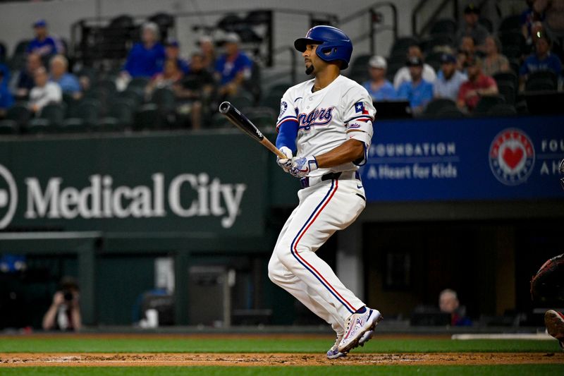 May 2, 2024; Arlington, Texas, USA; Texas Rangers second baseman Marcus Semien (2) hits a single and drives in a run against the Washington Nationals during the second inning at Globe Life Field. Mandatory Credit: Jerome Miron-USA TODAY Sports