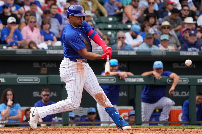 Mar 6, 2024; Mesa, Arizona, USA; Chicago Cubs second baseman Christopher Morel (5) hits against the Los Angeles Angels in the third inning at Sloan Park. Mandatory Credit: Rick Scuteri-USA TODAY Sports