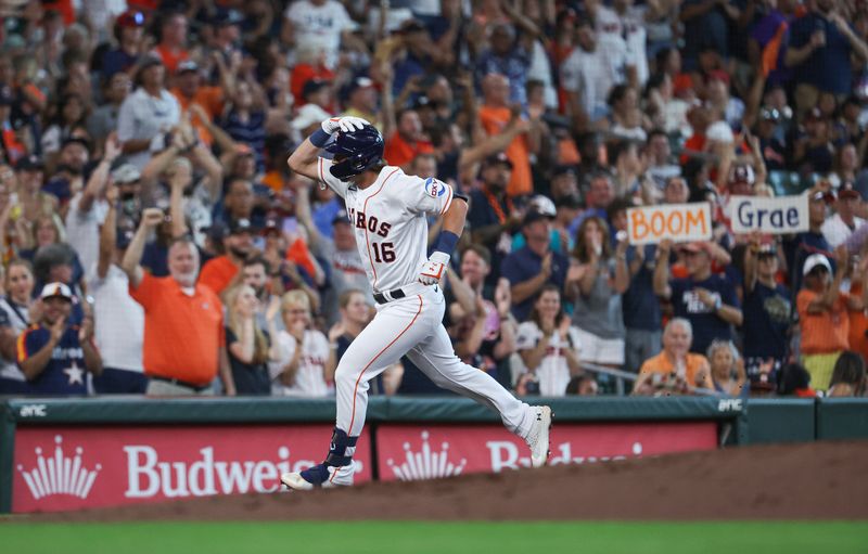 Jul 4, 2023; Houston, Texas, USA; Fans hold signs as Houston Astros shortstop Grae Kessinger (16) rounds the bases after hitting a home run during the third inning against the Colorado Rockies at Minute Maid Park. Mandatory Credit: Troy Taormina-USA TODAY Sports