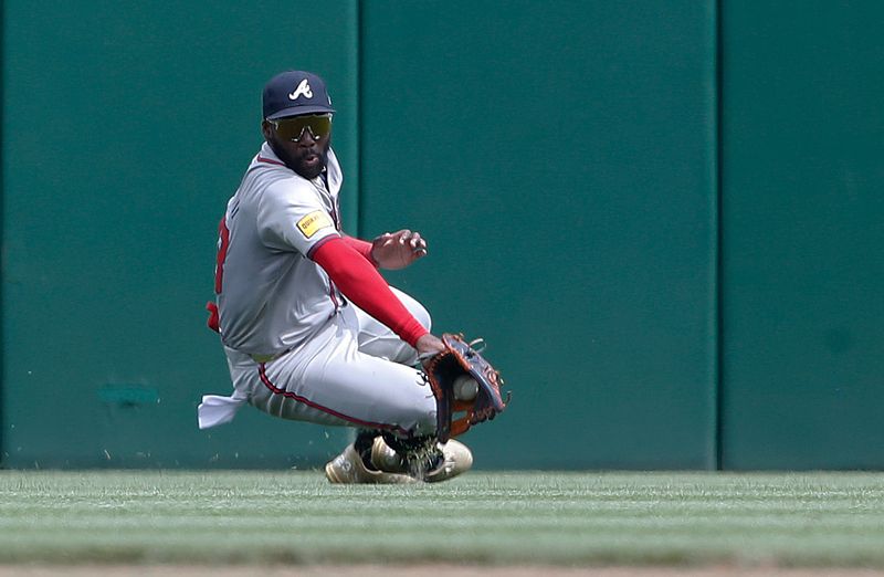 May 26, 2024; Pittsburgh, Pennsylvania, USA;  Atlanta Braves center fielder Michael Harris II (23) attempts to catch a ball hit for a single by Pittsburgh Pirates left fielder Bryan Reynolds (not pictured) during the sixth inning against at PNC Park. The ball was ruled to be trapped. Mandatory Credit: Charles LeClaire-USA TODAY Sports