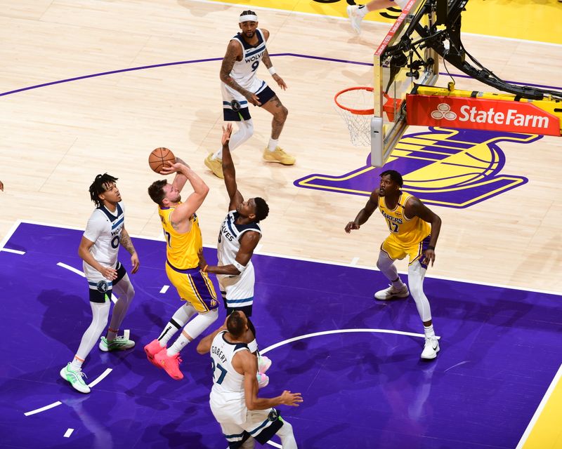 LOS ANGELES, CA - APRIL 22:  Luka Doncic #77 of the Los Angeles Lakers drives to the basket during the game against the Minnesota Timberwolves during Round 1 Game 2 of the 2025 NBA Playoffs on April 22, 2025 at Crypto.Com Arena in Los Angeles, California. NOTE TO USER: User expressly acknowledges and agrees that, by downloading and/or using this Photograph, user is consenting to the terms and conditions of the Getty Images License Agreement. Mandatory Copyright Notice: Copyright 2025 NBAE (Photo by Adam Pantozzi/NBAE via Getty Images)