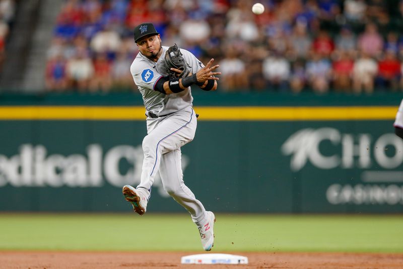 Aug 6, 2023; Arlington, Texas, USA; Miami Marlins second baseman Luis Arraez (3) fields a ground ball during the first inning against the Texas Rangers at Globe Life Field. Mandatory Credit: Andrew Dieb-USA TODAY Sports