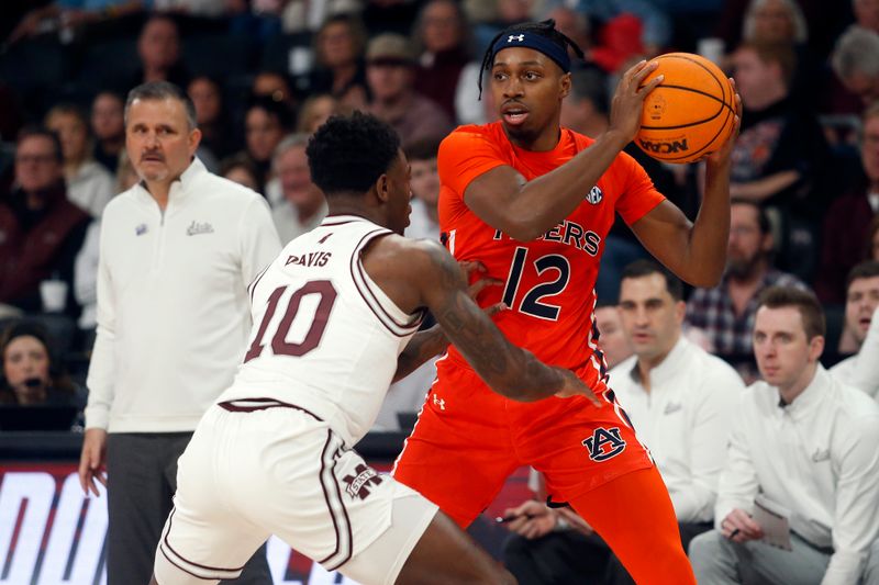 Jan 27, 2024; Starkville, Mississippi, USA; Auburn Tigers guard Denver Jones (12) handles the ball as Mississippi State Bulldogs guard Dashawn Davis (10) defends during the first half at Humphrey Coliseum. Mandatory Credit: Petre Thomas-USA TODAY Sports