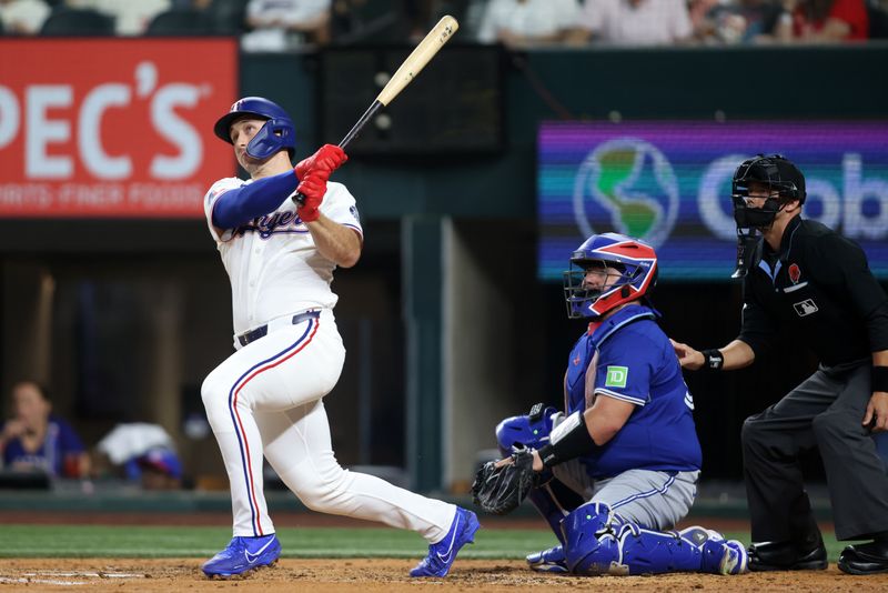 May 26, 2025; Arlington, Texas, USA; Texas Rangers outfielder Wyatt Langford (36) hits a solo home run during the fourth inning against the Toronto Blue Jays at Globe Life Field. Mandatory Credit: Tim Heitman-Imagn Images