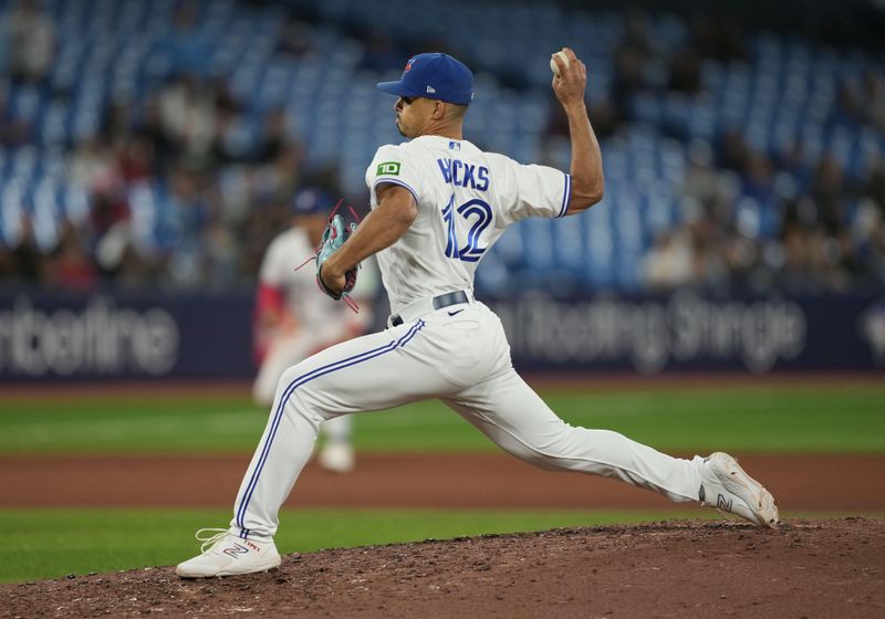 Sep 13, 2023; Toronto, Ontario, CAN; Toronto Blue Jays relief pitcher Jordan Hicks (12) throws a pitch against the Texas Rangers during the seventh inning at Rogers Centre. Mandatory Credit: Nick Turchiaro-USA TODAY Sports