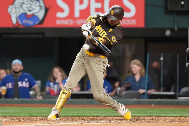 Jul 3, 2024; Arlington, Texas, USA; San Diego Padres catcher Kyle Higashioka (20) connects for an RBI single against the Texas Rangers during the sixth inning at Globe Life Field. Mandatory Credit: Jim Cowsert-USA TODAY Sports