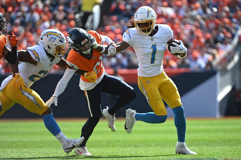 Los Angeles Chargers wide receiver Quentin Johnston (1) runs with the football during the first half of an NFL football game against the Denver Broncos, Sunday, Oct. 13, 2024, in Denver. (AP Photo/Geneva Heffernan)