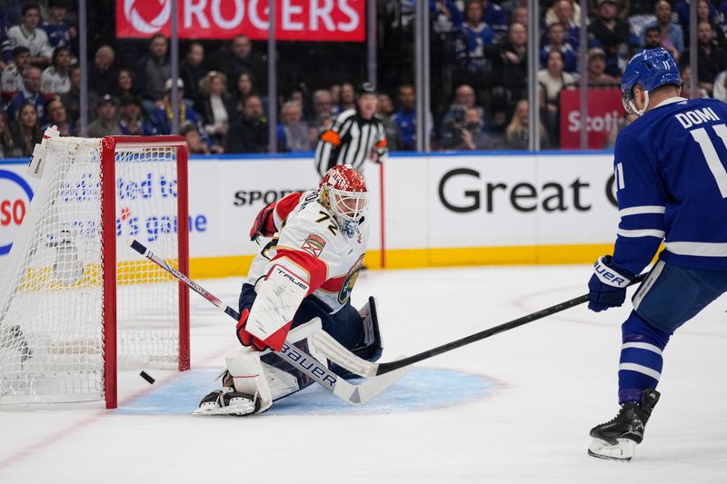 May 14, 2025; Toronto, Ontario, CAN; Florida Panthers goaltender Sergei Bobrovsky (72) makes a save against Toronto Maple Leafs forward Max Domi (11) during the first period of game five of the second round of the 2025 Stanley Cup Playoffs at Scotiabank Arena. Mandatory Credit: John E. Sokolowski-Imagn Images