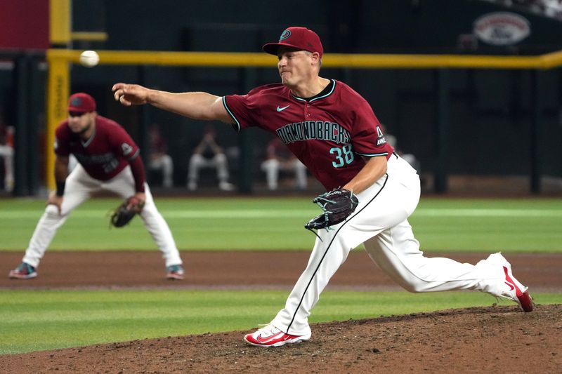 Jun 29, 2024; Phoenix, Arizona, USA; Arizona Diamondbacks pitcher Paul Sewald (38) throws against the Oakland Athletics in the ninth inning at Chase Field. Mandatory Credit: Rick Scuteri-USA TODAY Sports