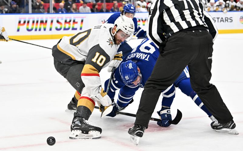 Feb 27, 2024; Toronto, Ontario, CAN;  Vegas Golden Knights forward Nicolas Roy (10) wins a faceoff against Toronto Maple Leafs forward John Tavares (91) in the first period at Scotiabank Arena. Mandatory Credit: Dan Hamilton-USA TODAY Sports