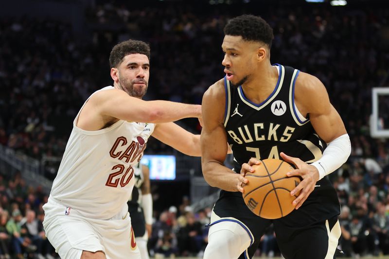 MILWAUKEE, WISCONSIN - JANUARY 26: Giannis Antetokounmpo #34 of the Milwaukee Bucks is defended by Georges Niang #20 of the Cleveland Cavaliers during the first half of a game at Fiserv Forum on January 26, 2024 in Milwaukee, Wisconsin. NOTE TO USER: User expressly acknowledges and agrees that, by downloading and or using this photograph, User is consenting to the terms and conditions of the Getty Images License Agreement. (Photo by Stacy Revere/Getty Images)