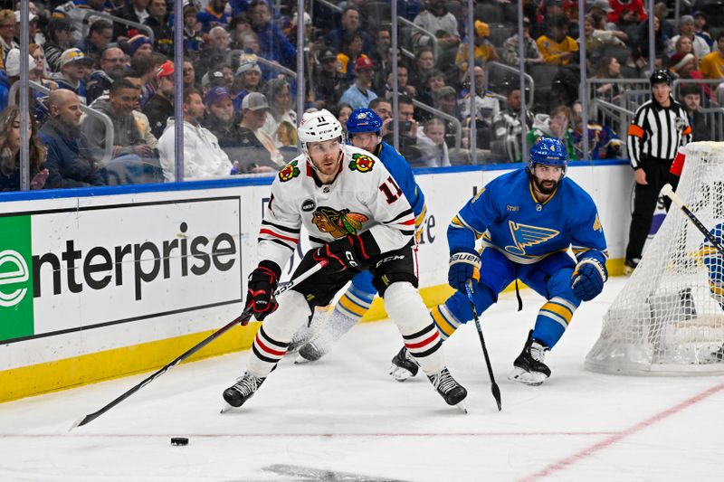 Dec 23, 2023; St. Louis, Missouri, USA;  Chicago Blackhawks right wing Taylor Raddysh (11) controls the puck against the St. Louis Blues during the first period at Enterprise Center. Mandatory Credit: Jeff Curry-USA TODAY Sports