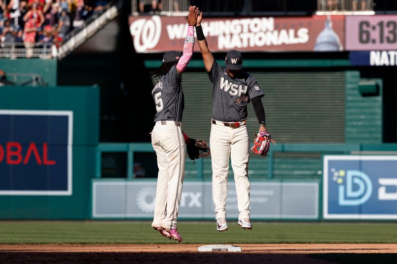 Jun 15, 2024; Washington, District of Columbia, USA; Washington Nationals shortstop CJ Abrams (5) celebrates with Nationals second base Luis García Jr. (2) after their game against the Miami Marlins at Nationals Park. Mandatory Credit: Geoff Burke-USA TODAY Sports