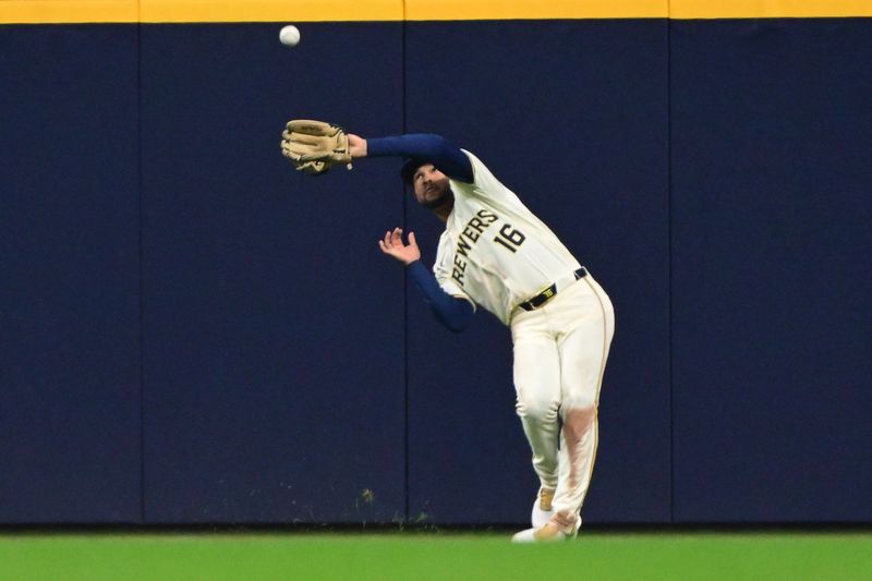 Apr 7, 2024; Milwaukee, Wisconsin, USA; Milwaukee Brewers center fielder Blake Perkins (16) catches fly ball  hit by Seattle Mariners catcher Seby Zavala (33) in the fourth inning at American Family Field. Mandatory Credit: Benny Sieu-USA TODAY Sports