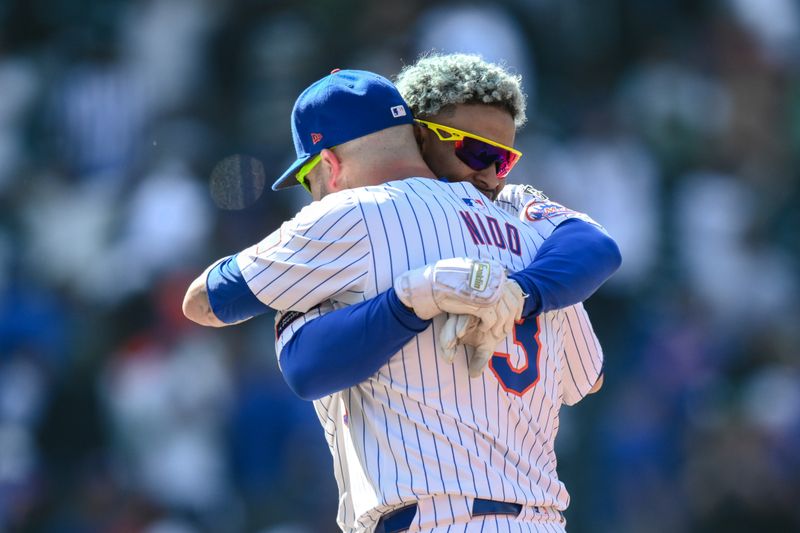 May 2, 2024; New York City, New York, USA; New York Mets shortstop Francisco Lindor (12) is hugged by New York Mets catcher Tomás Nido (3) after a walk off two RBI single against the Chicago Cubs during the eleventh inning at Citi Field. Mandatory Credit: John Jones-USA TODAY Sports