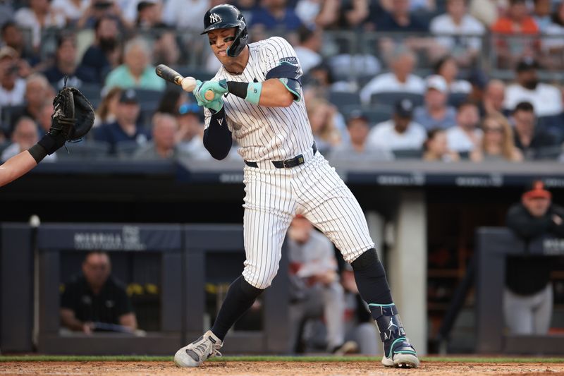 Jun 18, 2024; Bronx, New York, USA; New York Yankees center fielder Aaron Judge (99) is hit by a pitch during the third inning against the Baltimore Orioles at Yankee Stadium. Mandatory Credit: Vincent Carchietta-USA TODAY Sports