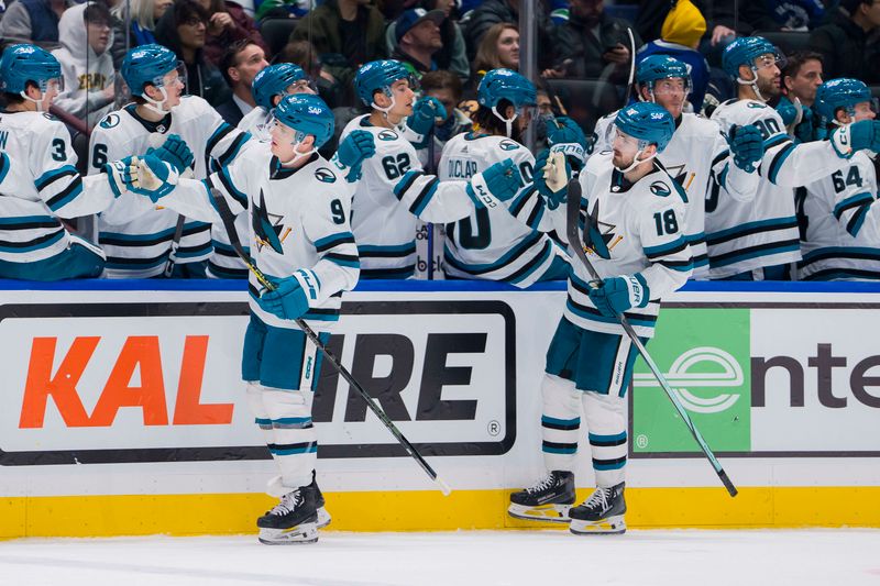 Dec 23, 2023; Vancouver, British Columbia, CAN; San Jose Sharks defenseman Jacob MacDonald (9) and forward Filip Zadina (18) celebrate MacDonald   s goal against the Vancouver Canucks in the third period at Rogers Arena. Canucks won 7-4. Mandatory Credit: Bob Frid-USA TODAY Sports