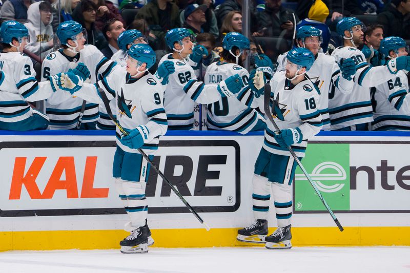 Dec 23, 2023; Vancouver, British Columbia, CAN; San Jose Sharks defenseman Jacob MacDonald (9) and forward Filip Zadina (18) celebrate MacDonald   s goal against the Vancouver Canucks in the third period at Rogers Arena. Canucks won 7-4. Mandatory Credit: Bob Frid-USA TODAY Sports